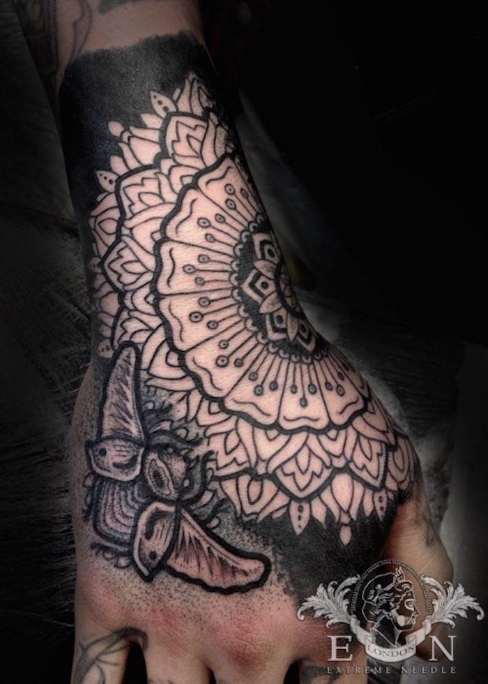 On hand beetle dotwork tattoo