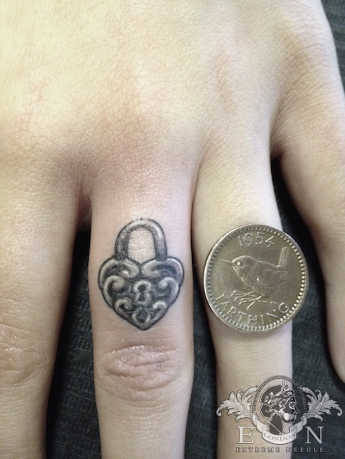 Penny size padlock tattoo