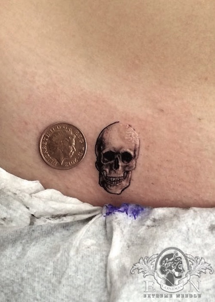 Penny size skull tattoo